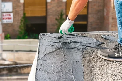 Jebco worker repairing a roof with a trowel