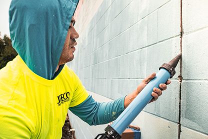 Jebco worker repairing a wall